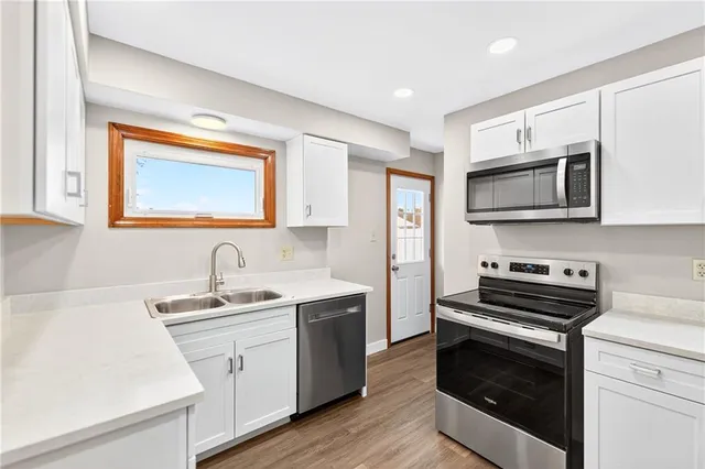 a kitchen with a sink stove and microwave