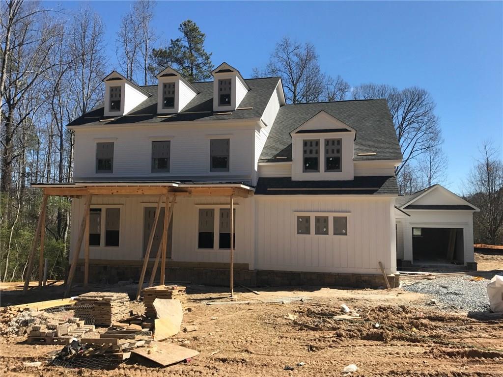 Stunning stone and siding home featuring dual car side entry garage and 3rd car extended carriage garage. 