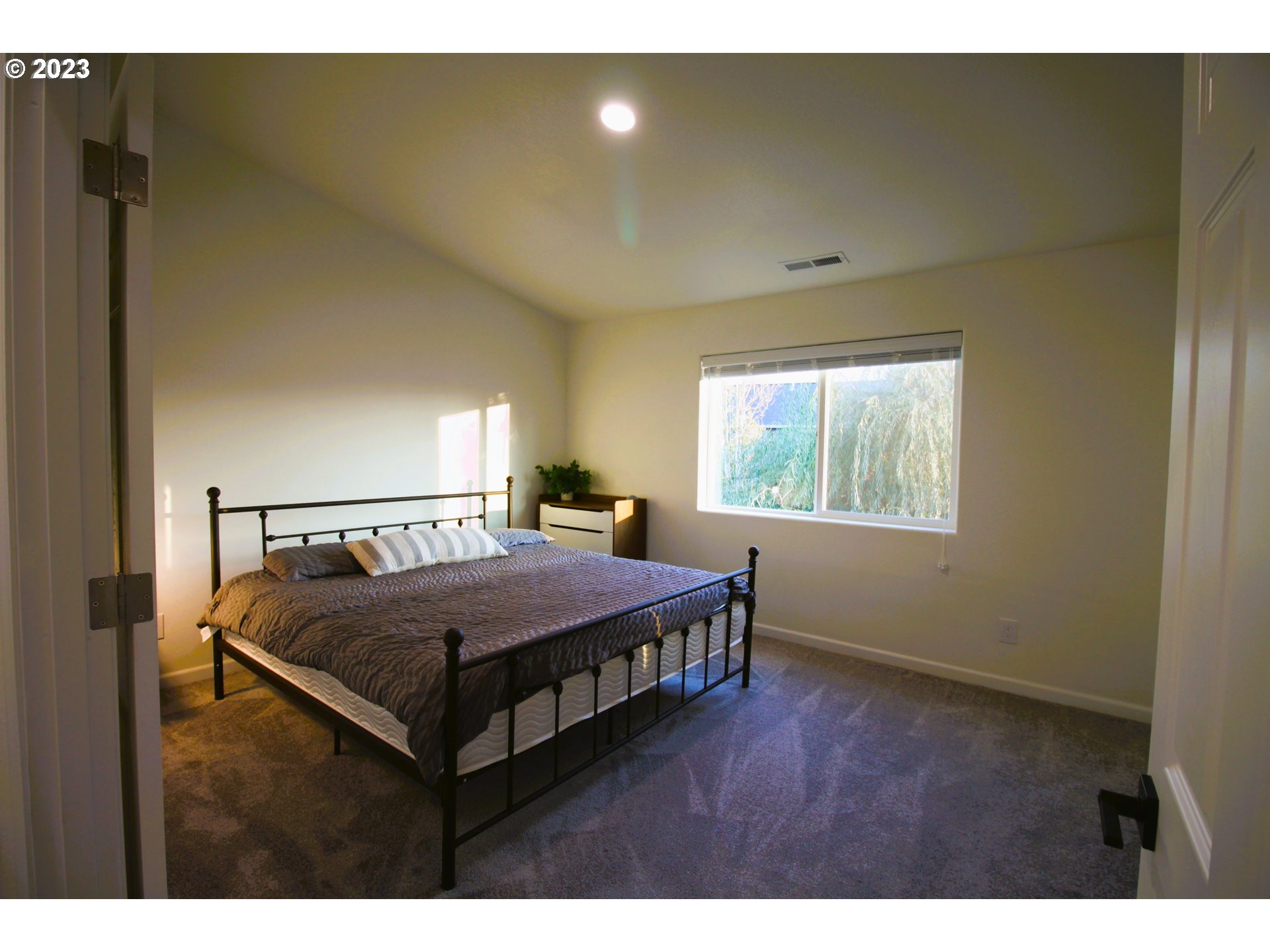 3864 Aerial Way Eugene, OR 97402 - Photo 9 of 22 a bedroom with a bed window and mirror