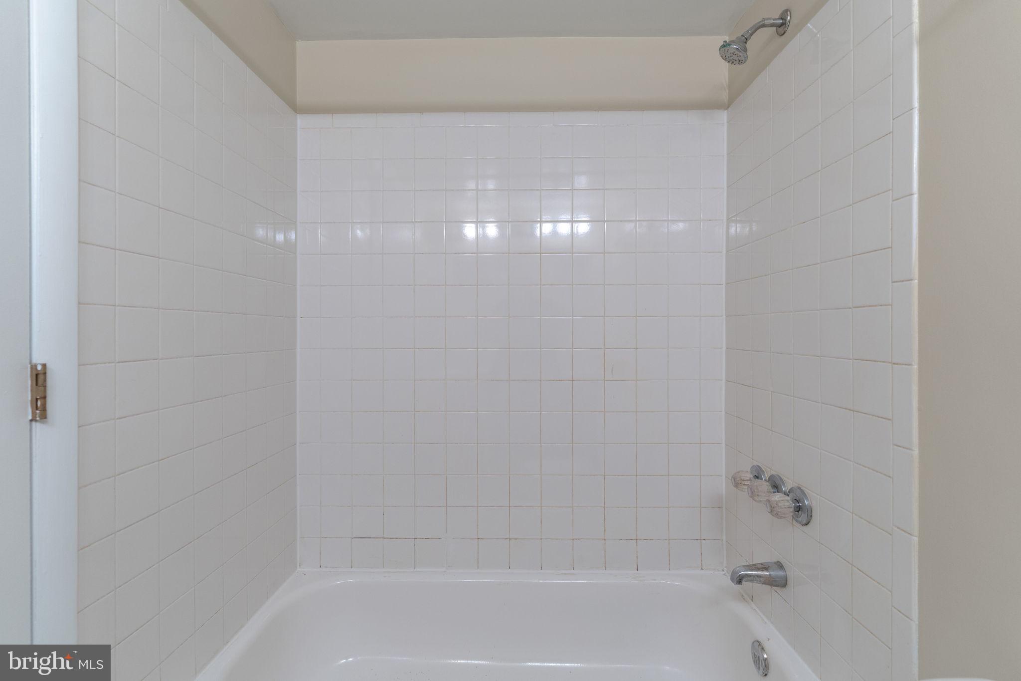 9653 White Acre Road, Unit B2 Columbia, MD 21045 - Photo 21 of 28 a close up of a bathtub in a bathroom