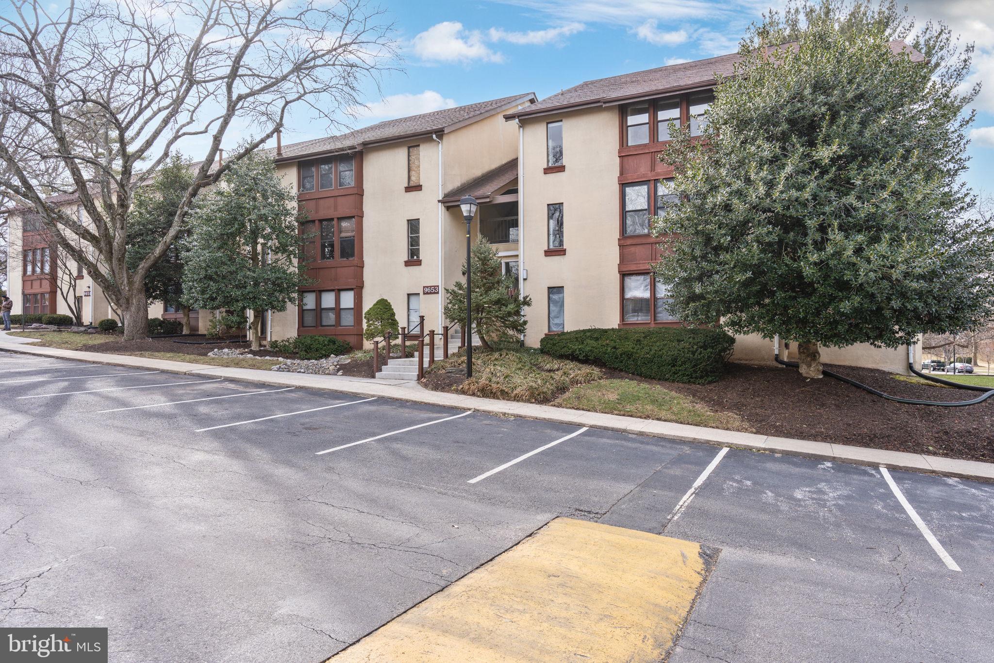 9653 White Acre Road, Unit B2 Columbia, MD 21045 - Photo 3 of 28 a row of palm trees in front of a building