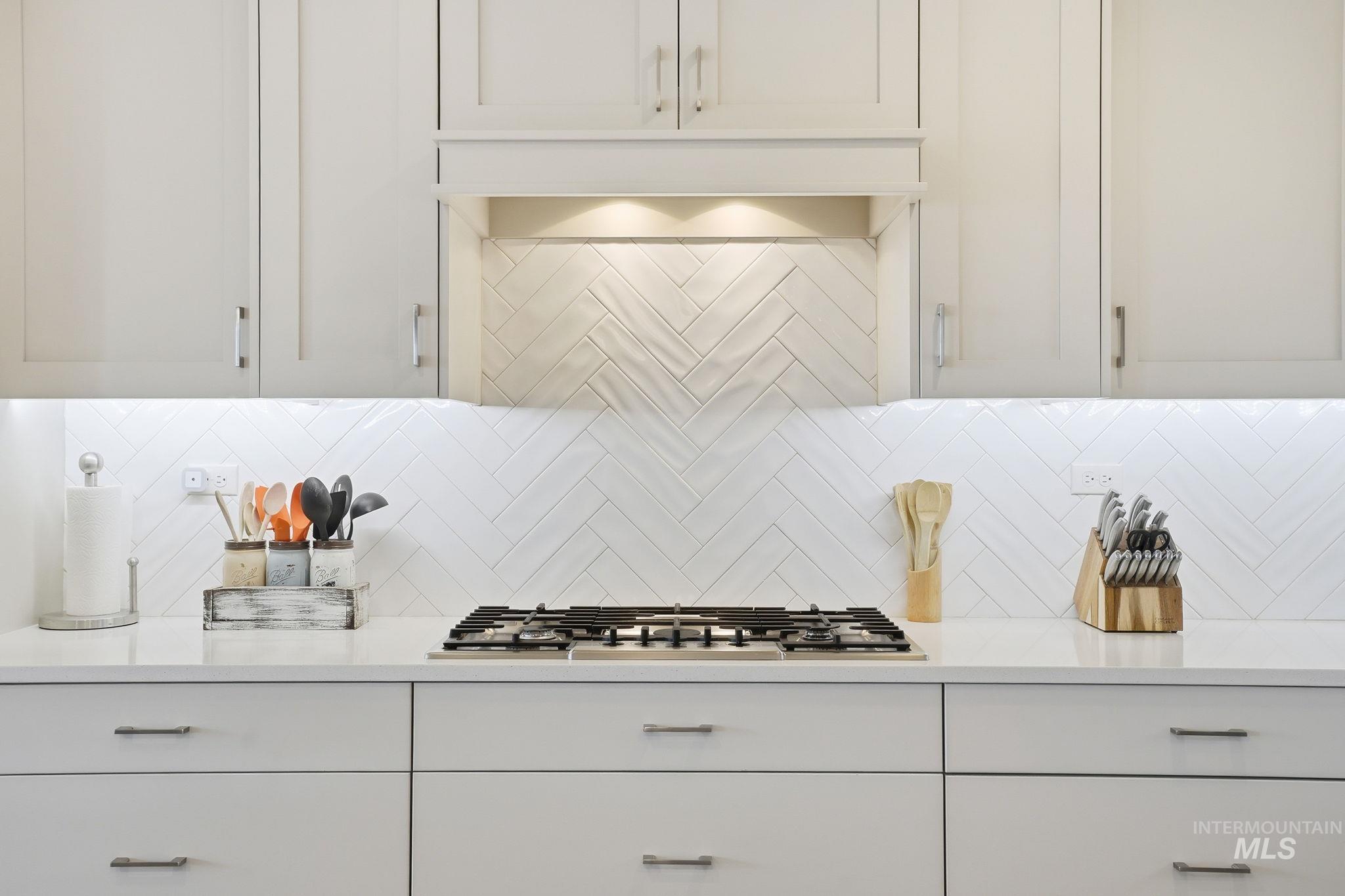 2301 Nordic Avenue Middleton, ID 83644 - Photo 12 of 50 Kitchen with white cabinetry, light stone countertops, and stainless steel gas stovetop