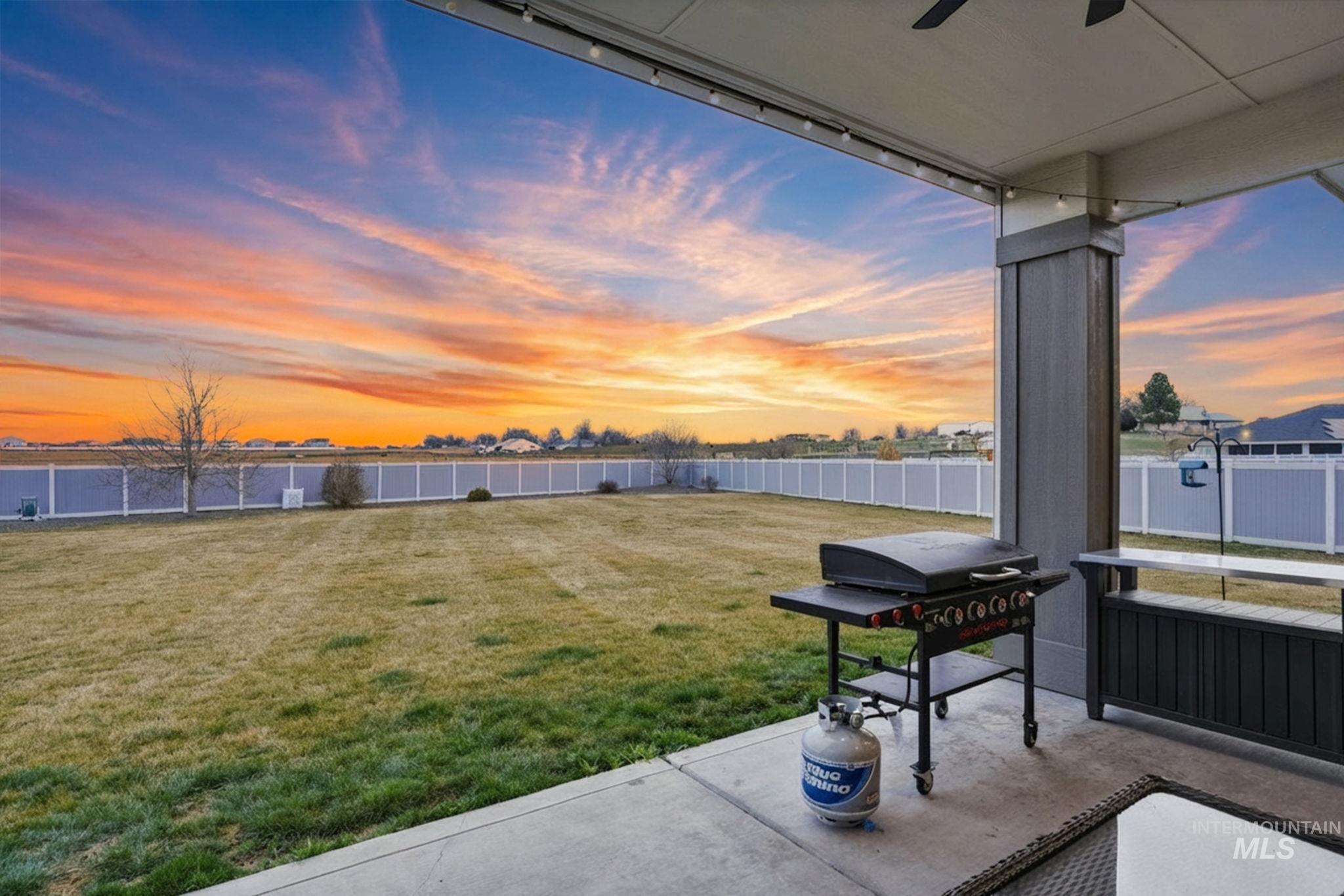2301 Nordic Avenue Middleton, ID 83644 - Photo 37 of 50 Yard at dusk featuring a fenced backyard, a patio, and a ceiling fan