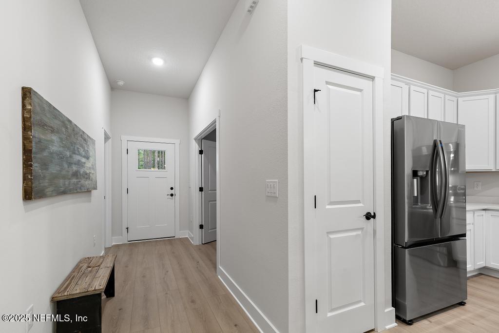 5124 Parete Road South Jacksonville, FL 32218 - Photo 13 of 42 a view of a kitchen with a refrigerator cabinets and a wooden floor