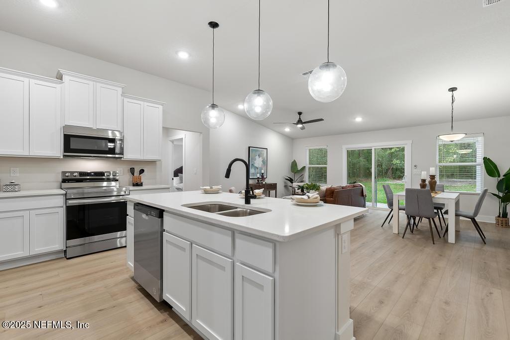 5124 Parete Road South Jacksonville, FL 32218 - Photo 14 of 42 a large kitchen with kitchen island a large island in it