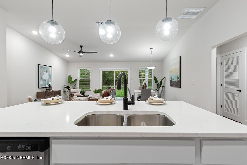 5124 Parete Road South Jacksonville, FL 32218 - Photo 15 of 42 a kitchen with a sink a counter and chairs