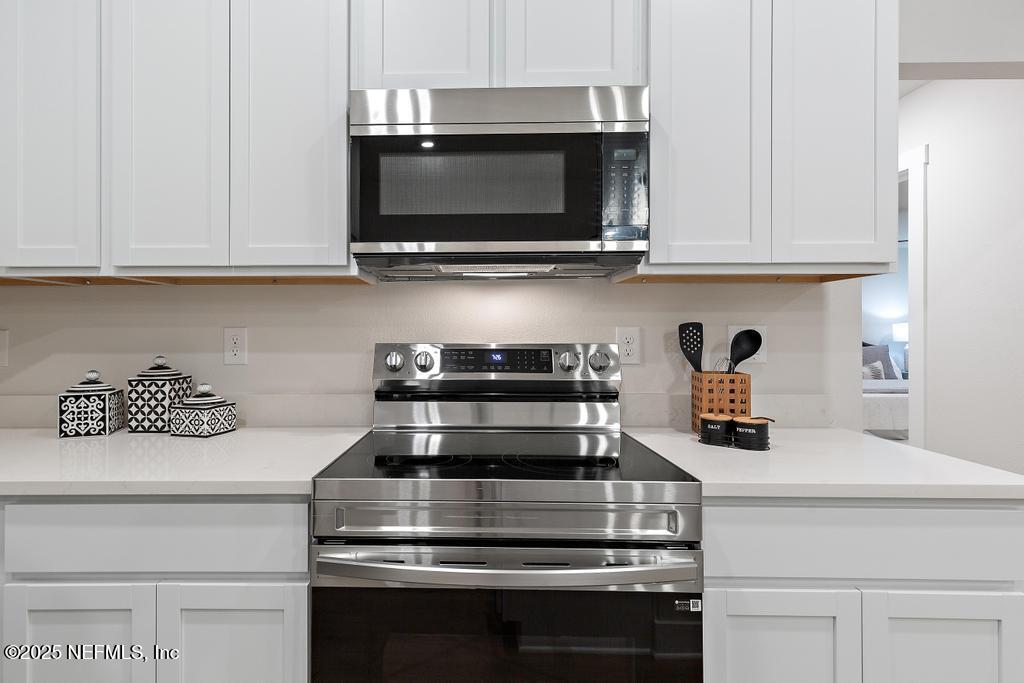 5124 Parete Road South Jacksonville, FL 32218 - Photo 16 of 42 a kitchen with appliances a microwave and cabinets