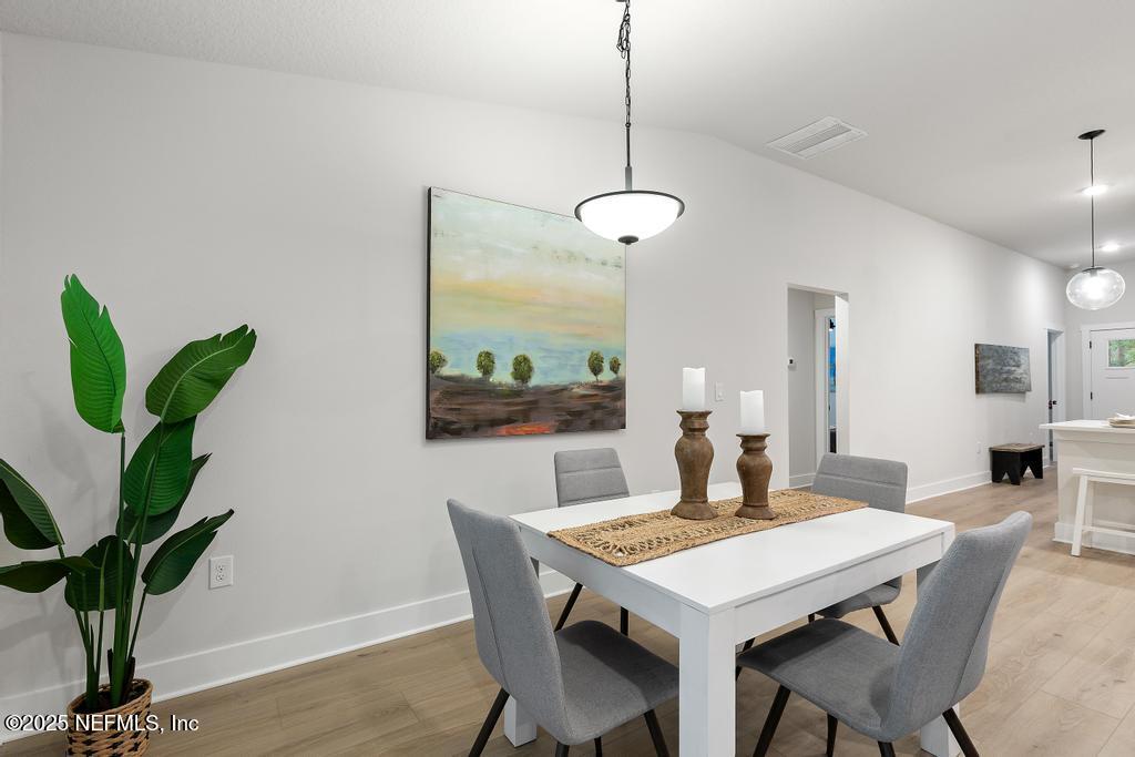 5124 Parete Road South Jacksonville, FL 32218 - Photo 23 of 42 a view of a dining room with furniture and wooden floor