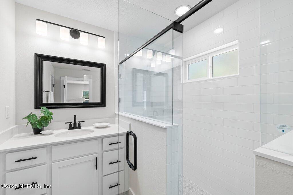 5124 Parete Road South Jacksonville, FL 32218 - Photo 32 of 42 a bathroom with a sink vanity and mirror