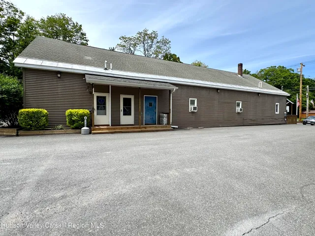 front view of a house with a bench