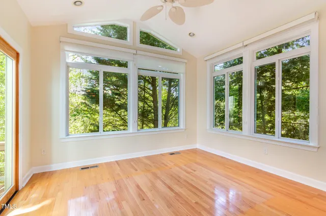 a spacious bedroom with a bed and a chandelier