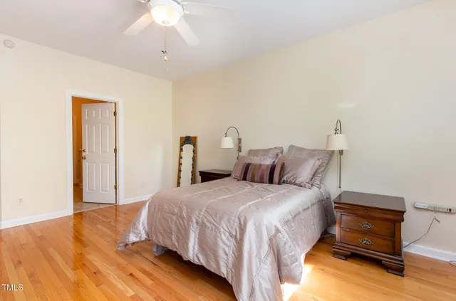 a spacious bathroom with a granite countertop sink a mirror and a shower