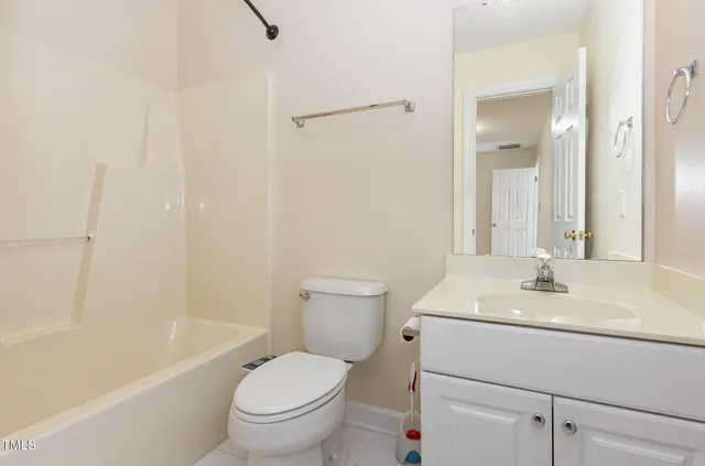 a bathroom with a granite countertop sink two mirror and a shower