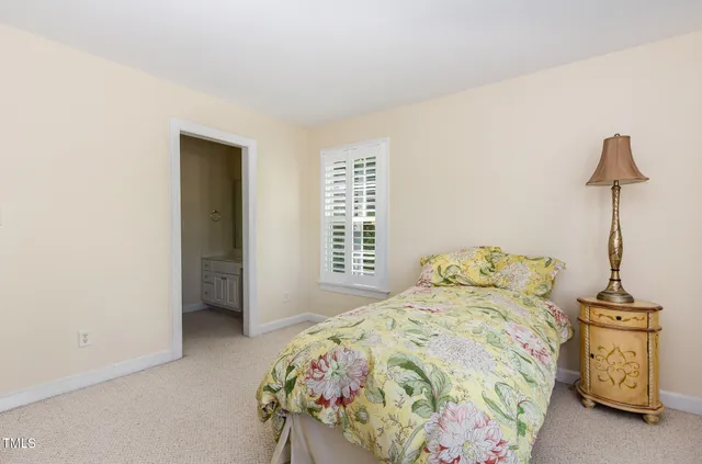 a bedroom with a bed and a wooden floor