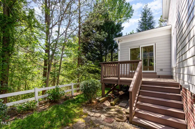 a front view of a house with a tree