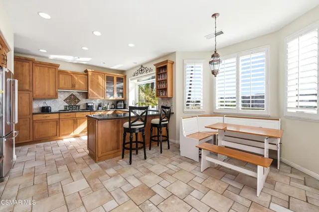 a kitchen with stainless steel appliances kitchen island granite countertop a sink and cabinets