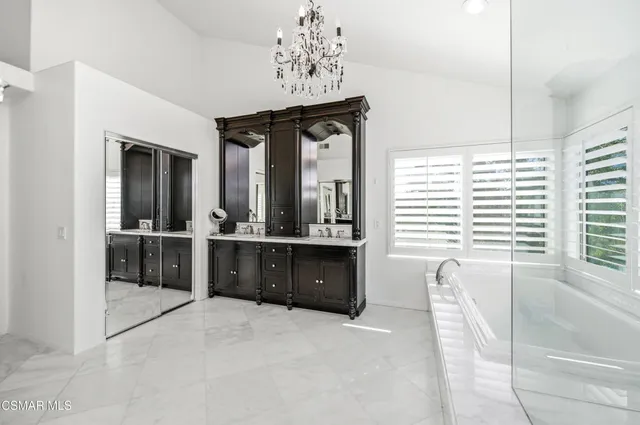 a bathroom with a double vanity sink and a bathtub