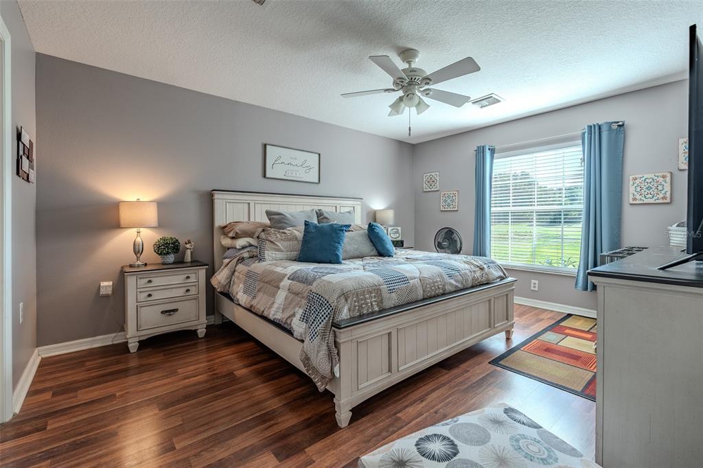 15143 Southwest 14th Avenue Road Ocala, FL 34473 - Photo 21 of 53 a bedroom with a bed and a chandelier