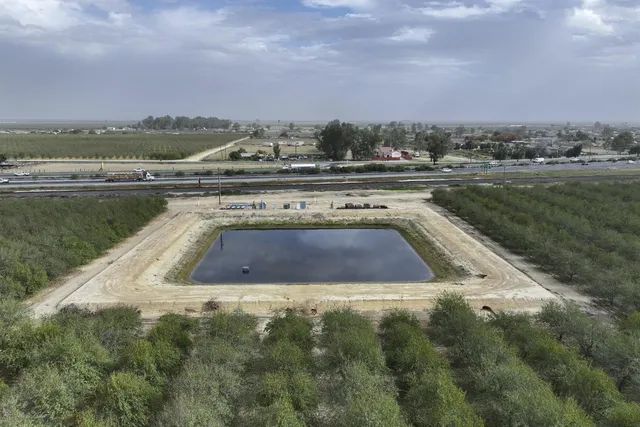 a view of a swimming pool and an outdoor seating
