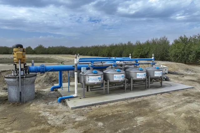 an outdoor sitting area with couch and a fireplace