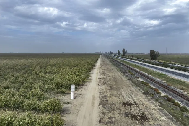 a view of an ocean beach and mountain in the back
