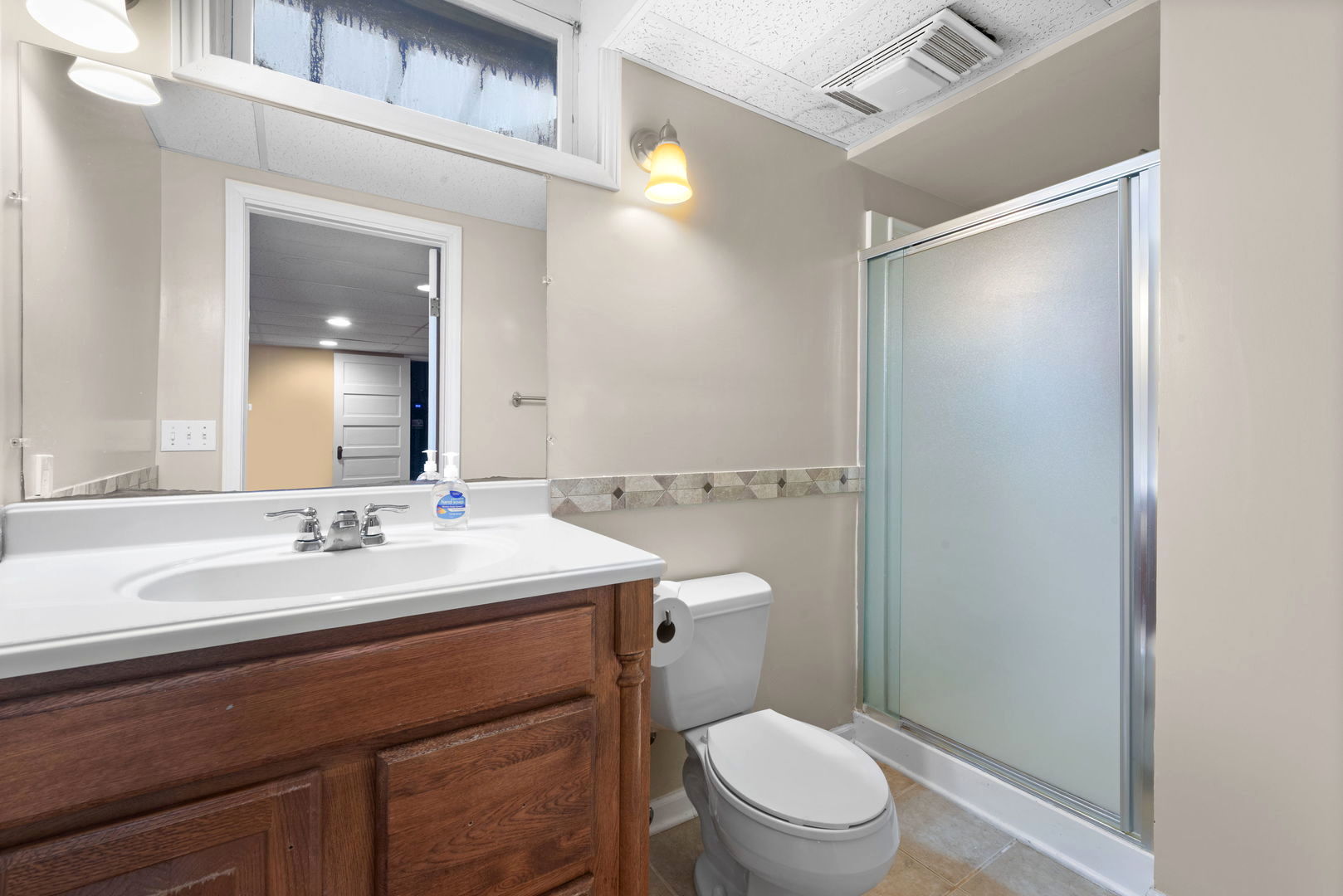 43W836 Hughes Road Elburn, IL 60119 - Photo 11 of 17 a bathroom with a sink a toilet a mirror and shower