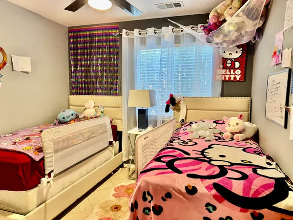 a bedroom with a bed and dresser in it