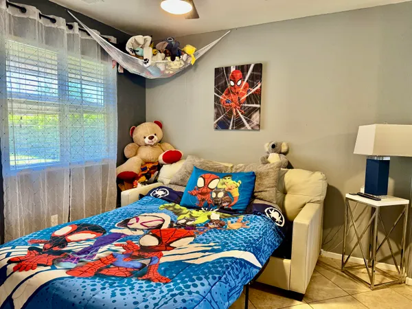 a bedroom with a bed and a large window