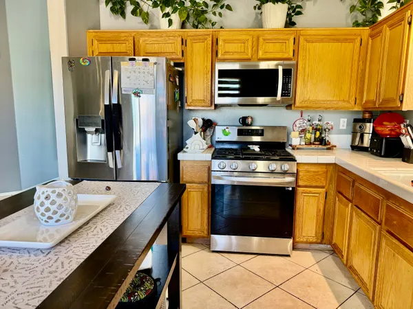 a kitchen with stainless steel appliances a stove microwave and refrigerator