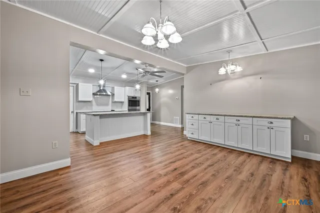 a view of a kitchen with a dishwasher cabinets and wooden floor