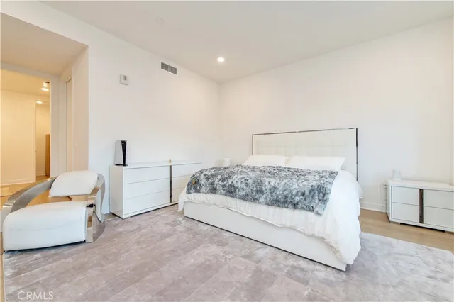 a bedroom with a bed and white walls