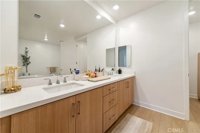 a bathroom with a double vanity sink and mirror