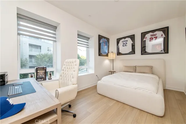 a bedroom with a bed and wooden floor