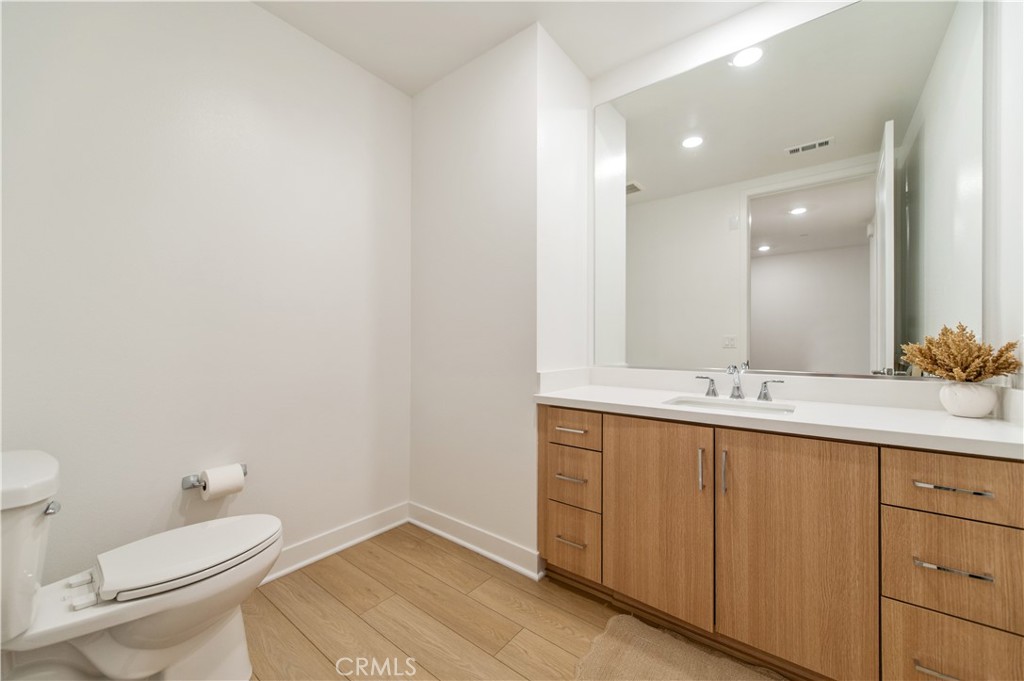 1209 Rivington Irvine, CA 92612 - Photo 19 of 38 a bathroom with a toilet a sink and mirror