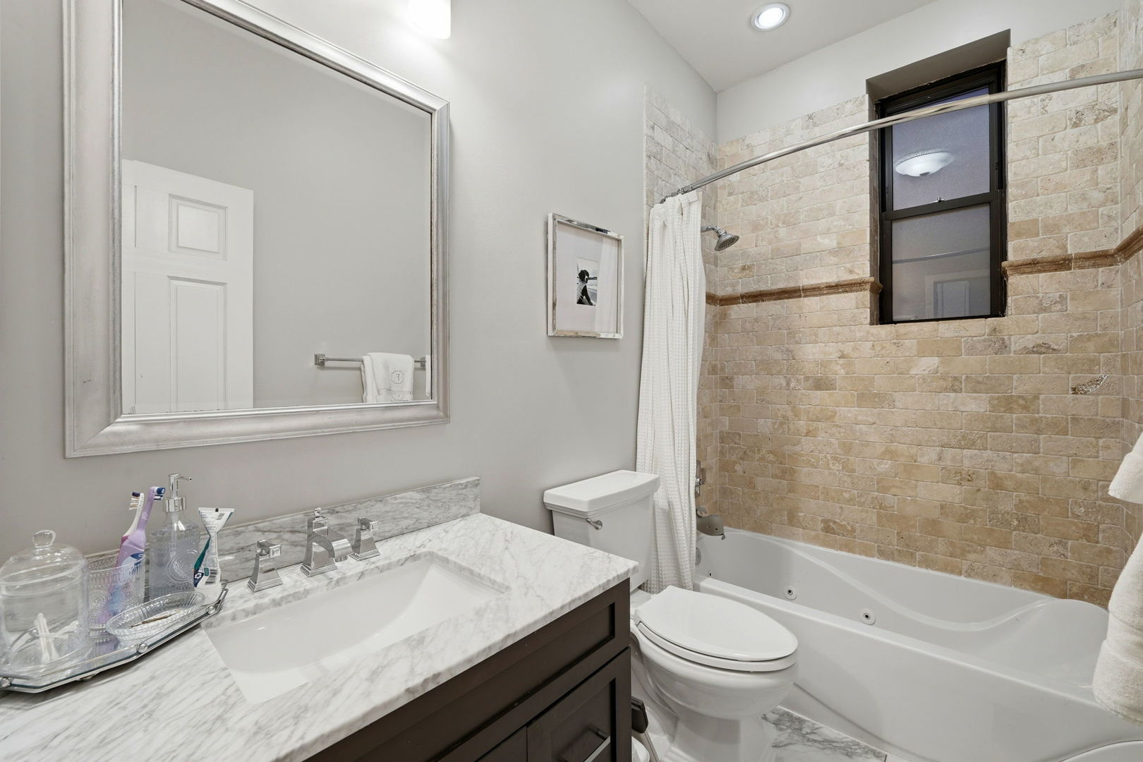 2142 North Racine Avenue, Unit 1 Chicago, IL 60614 - Photo 17 of 30 a bathroom with a granite countertop sink toilet and shower