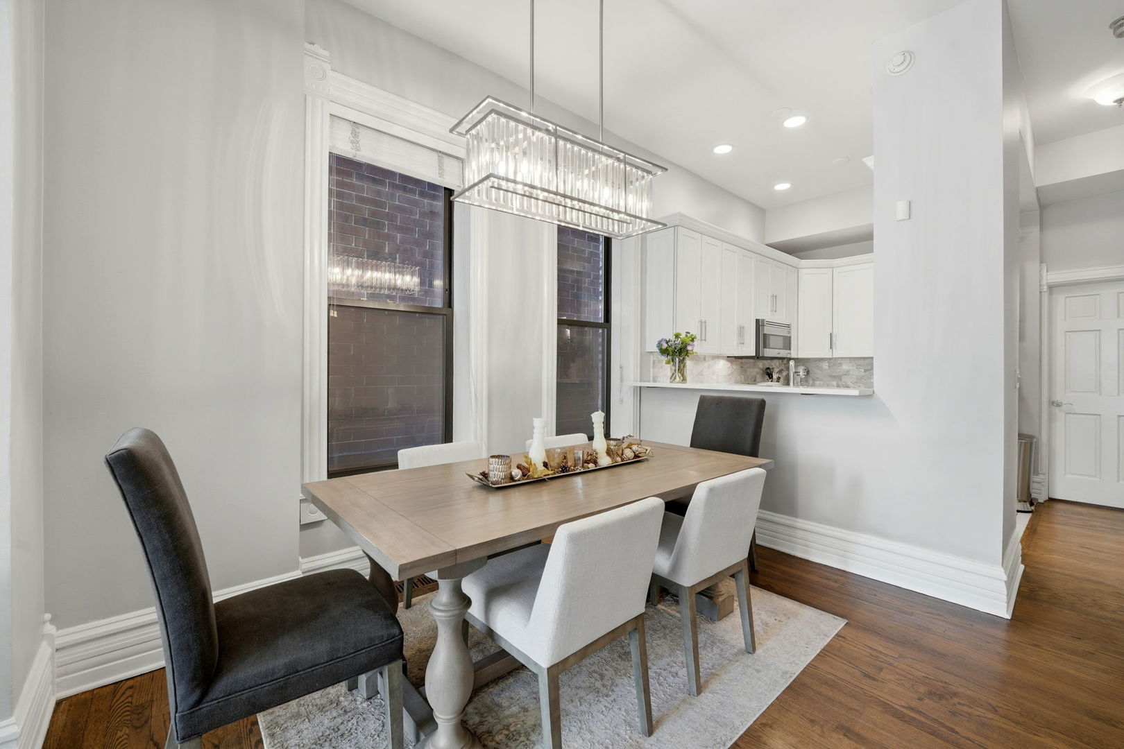 2142 North Racine Avenue, Unit 1 Chicago, IL 60614 - Photo 6 of 30 a dining room with furniture a chandelier and wooden floor
