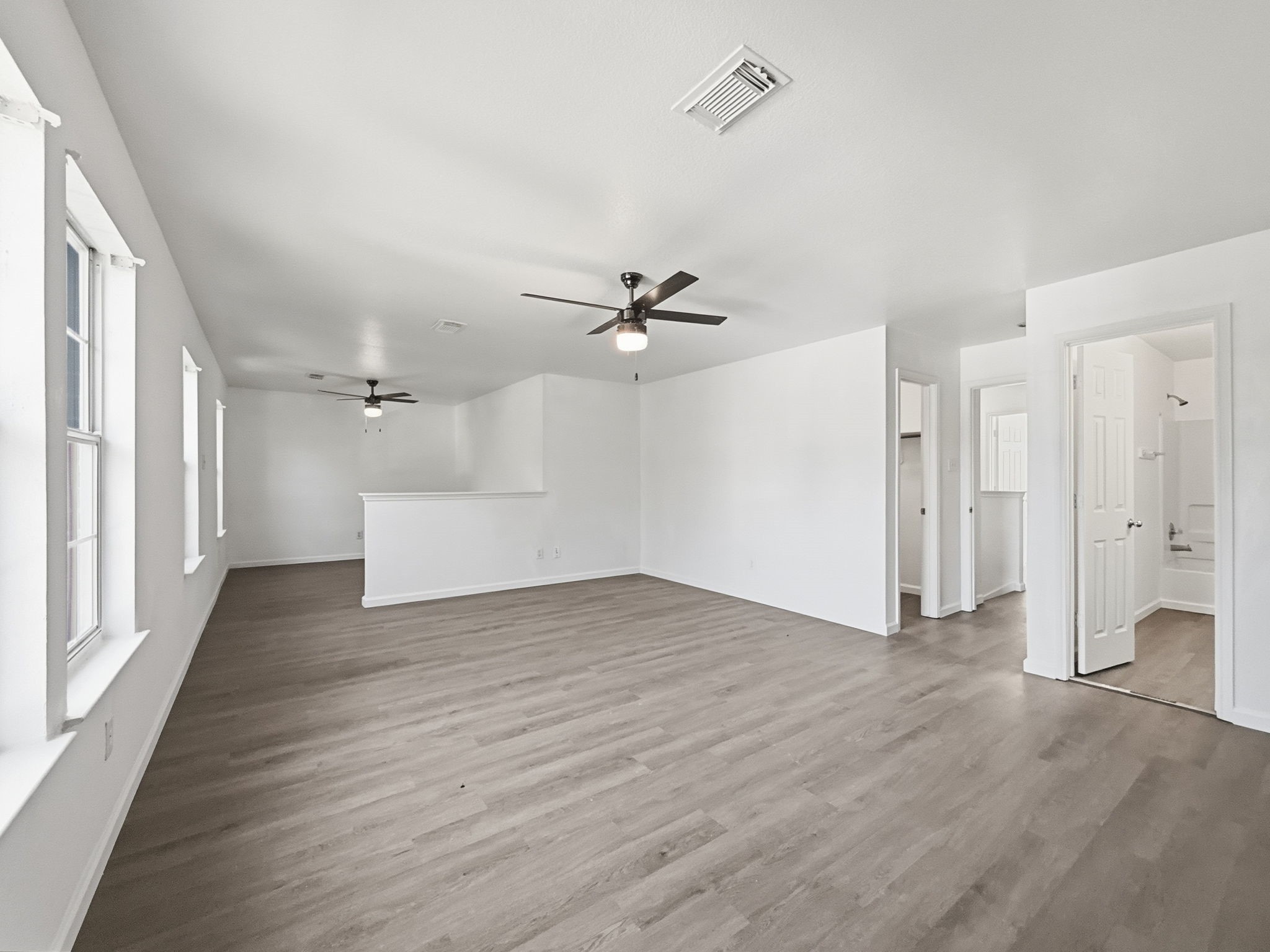 4907 Fox Mill Lane Spring, TX 77389 - Photo 8 of 18 wooden floor in an empty room with a window