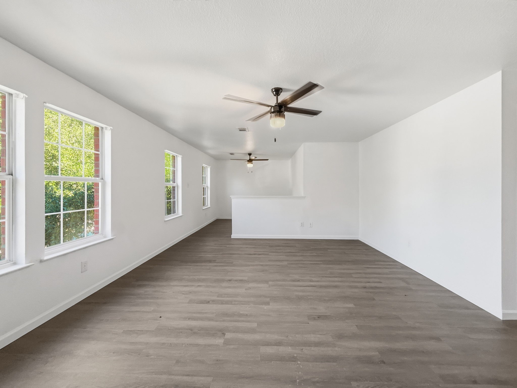 4907 Fox Mill Lane Spring, TX 77389 - Photo 9 of 18 a view of empty room with wooden floor and fan