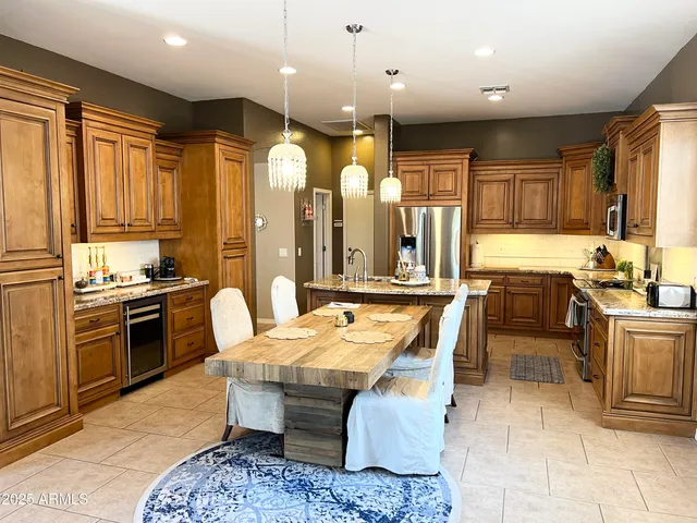 a large kitchen with lots of counter space a sink and appliances