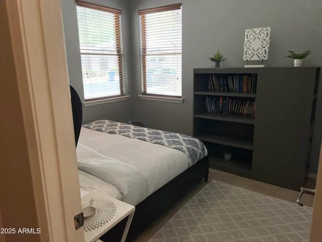 a bedroom with a bed and a window