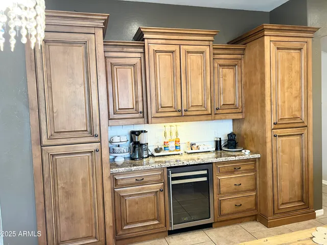 a kitchen with stainless steel appliances granite countertop a refrigerator and cabinets