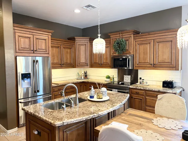 a kitchen with granite countertop a sink and cabinets