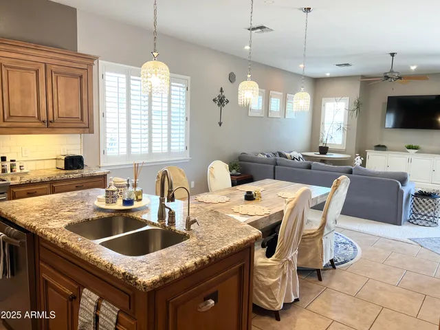 a kitchen with granite countertop a sink a counter top space appliances and cabinets