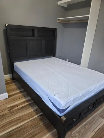 a bed sitting in a bedroom next to a cabinet