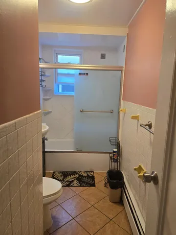 a bathroom with a toilet and a shower