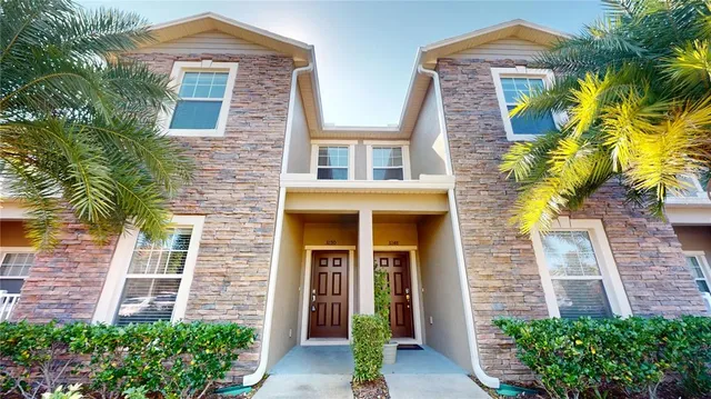 front view of a brick house with a yard