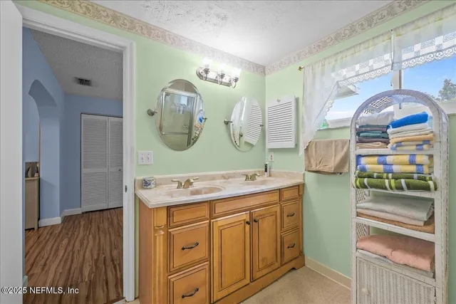 a bathroom with a sink mirror and vanity