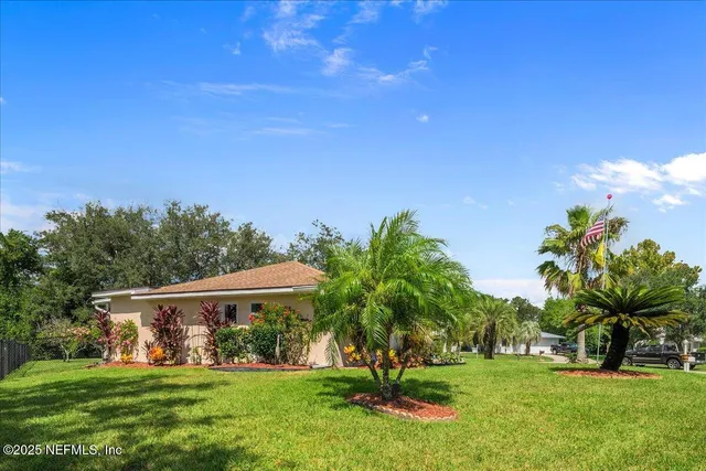 a view of an house with backyard space and garden