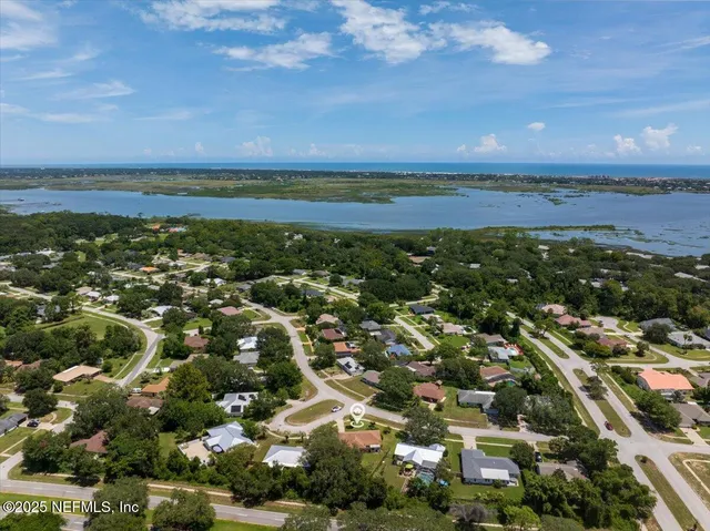 an aerial view of residential building and ocean
