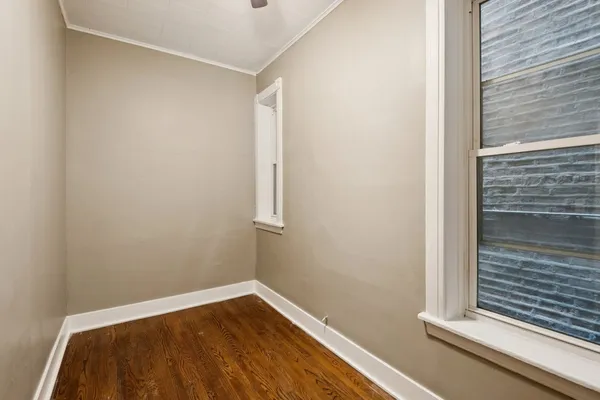 a view of a room with wooden floor and fence